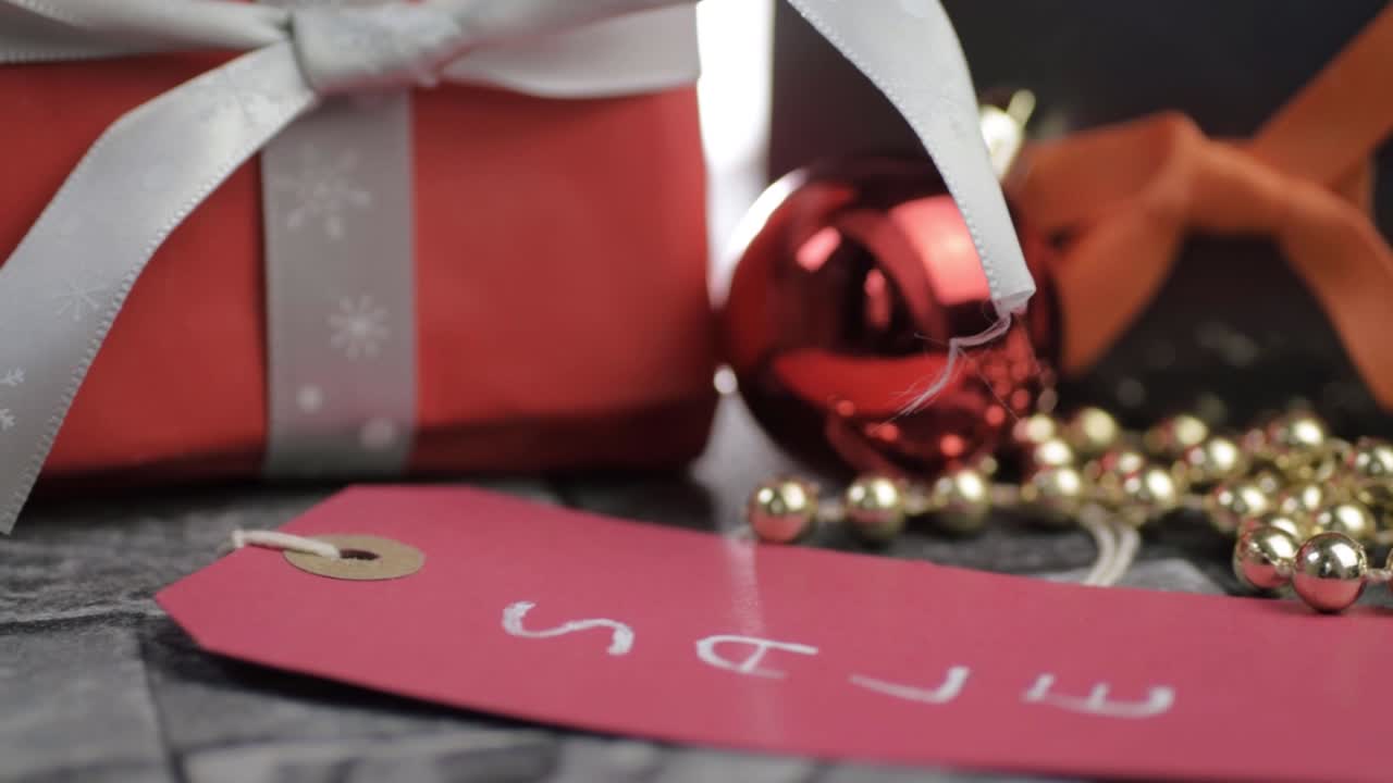 Display of Christmas gifts and decorations in a sale close up panning shot