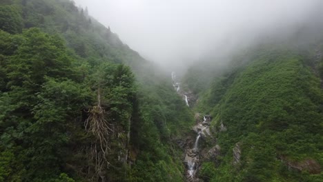 aerial journey up a seemingly never-ending series of stepped waterfalls on a misty morning in the high country of rize, turkiye