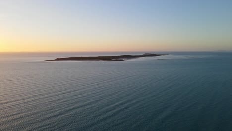 Flock-Pigeon-Island-During-Golden-Sunset-Near-Clairview-Beach-In-QLD,-Australia