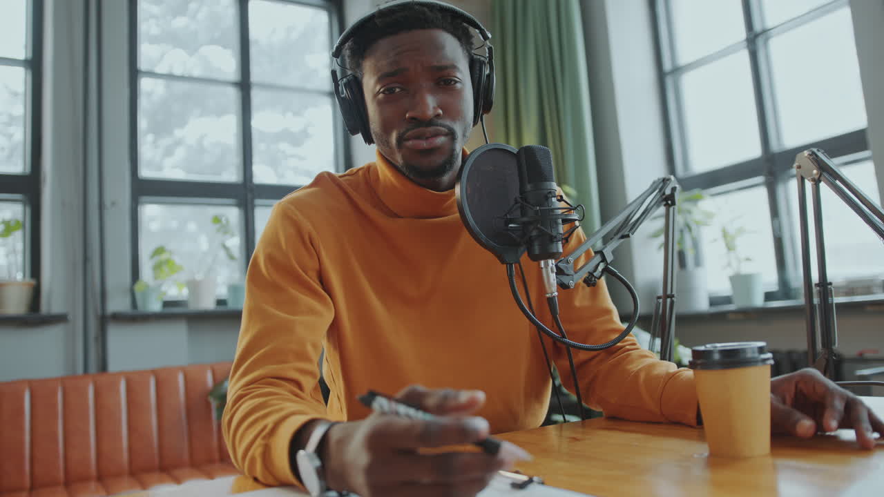 African American Video Blogger Talking at Camera in Recording Studio
