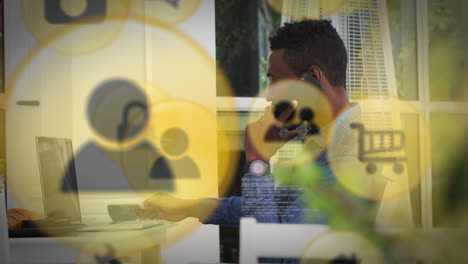multiple digital icons against african american man holding coffee cup talking on smartphone