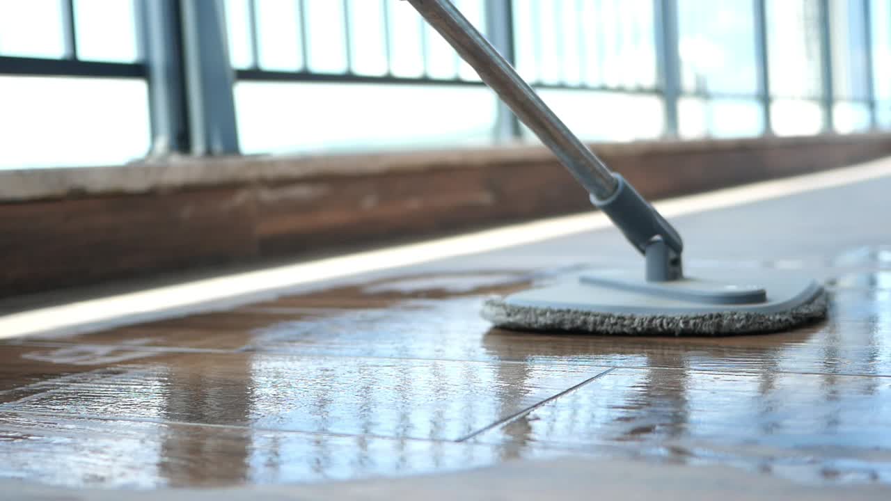 Mop cleaning a tiled floor