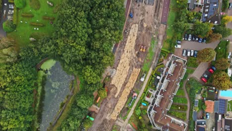 top down aerial of an unfinished road under construction in a small, rural town in the netherlands
