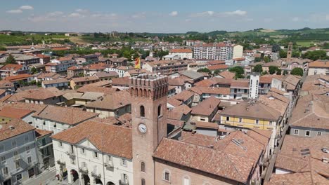 nizza monferrato, unesco site, asti, piedmont, italy. 4k aerial view of the city hall and central square. langhe-roero and monferrato. circling to the left around the tower.