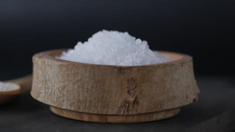 close-up of coarse sea salt in a rustic wooden bowl