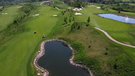 aerial drone view of golf course pond and