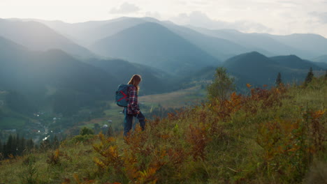 active millennial travel mountains nature. young woman trekking on landscape.