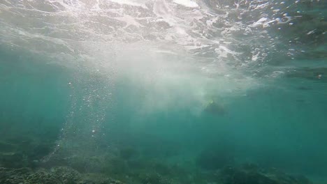 Girl-snorkeling-with-fins-in-the-coral-of-Komodo,-Indonesia