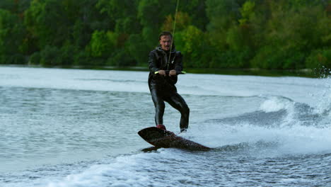 man wakeboarding on river