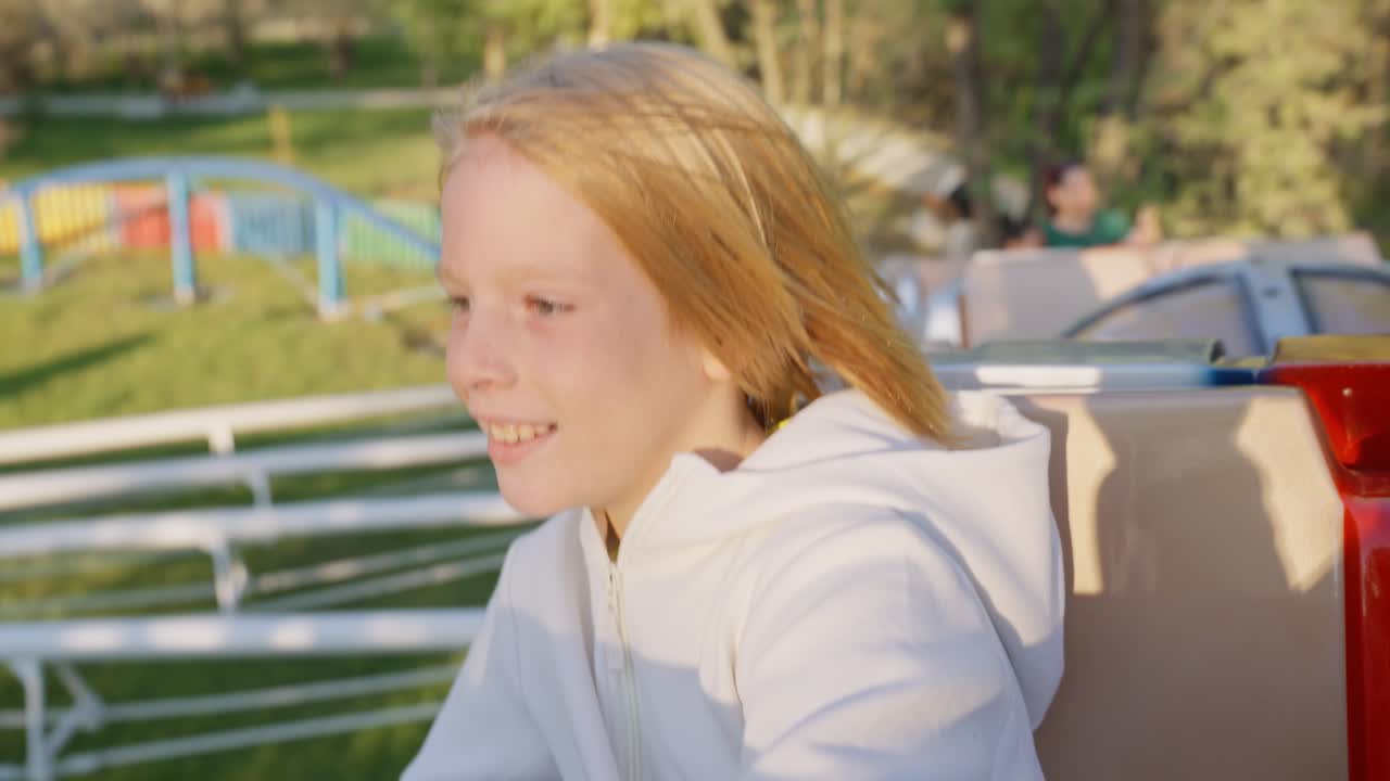 Child having fun on amusement park ride