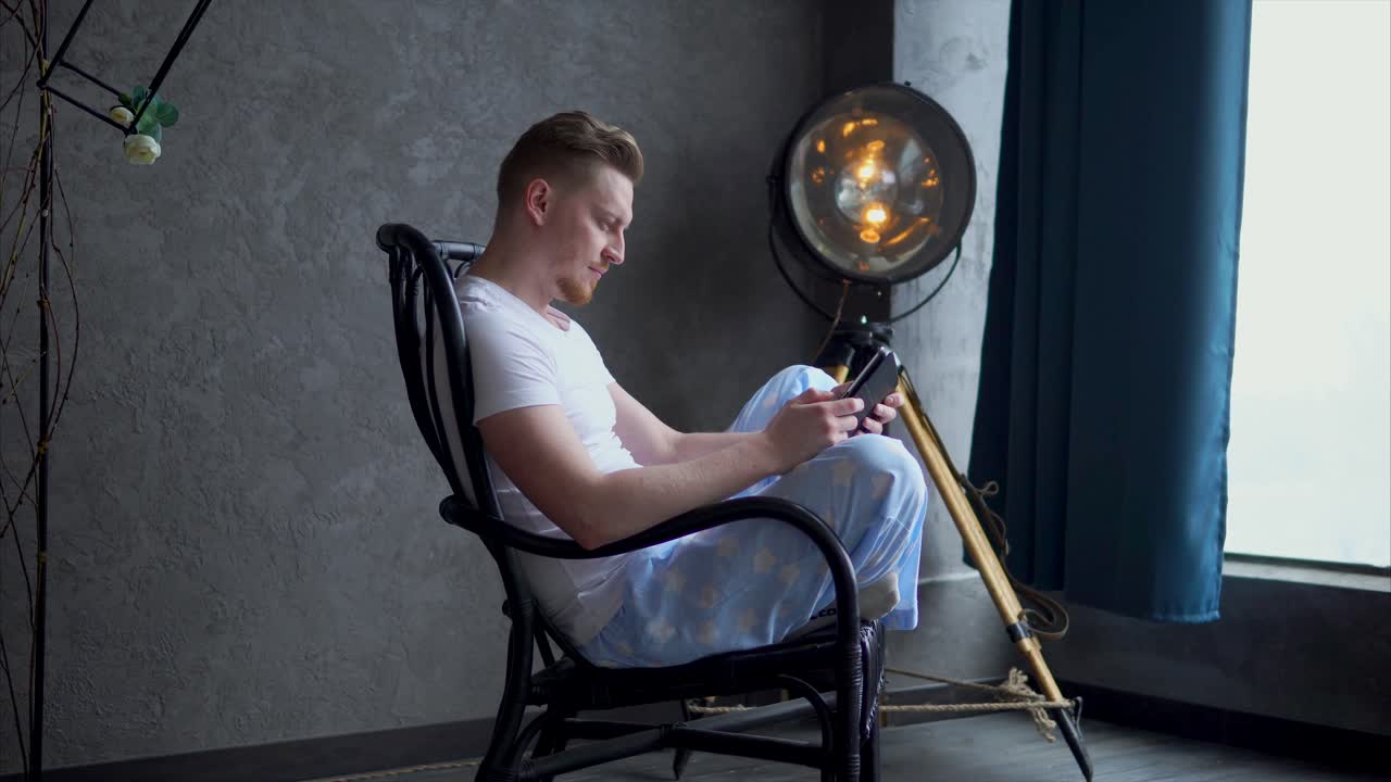 Man using phone in a chair