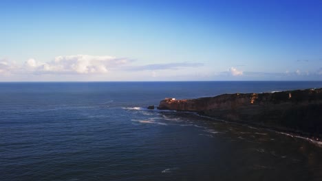 an iconic place on the atlantic coast, the mecca of big-wave surfing. view of nazare's lighthouse in zon north canyon, place with the biggest waves in europe, nazare, portugal