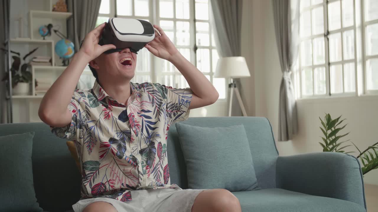 Man wearing VR headset and enjoying virtual reality experience at home