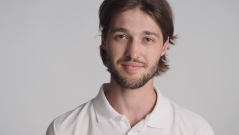 caucasian man in front of camera on gray background.