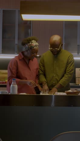 mature couple playing in the kitchen