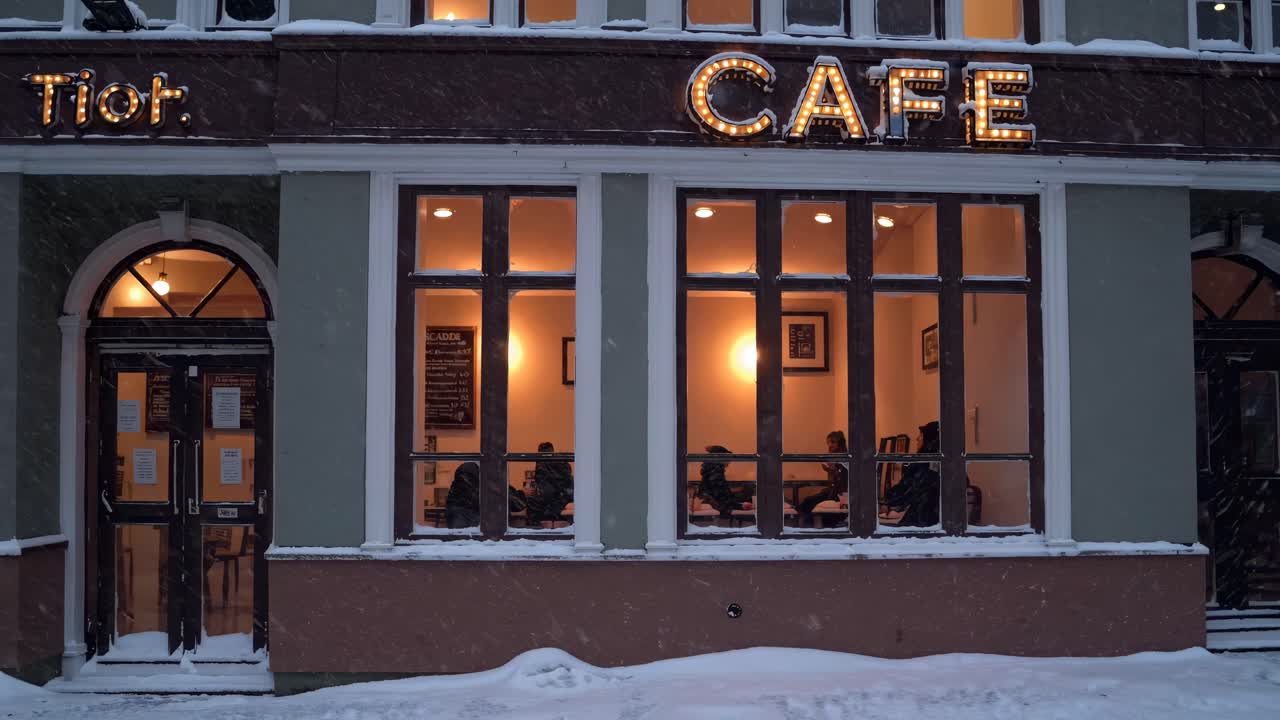 Warm, inviting cafe scene shot from a low angle, showcasing cozy interior lighting through large