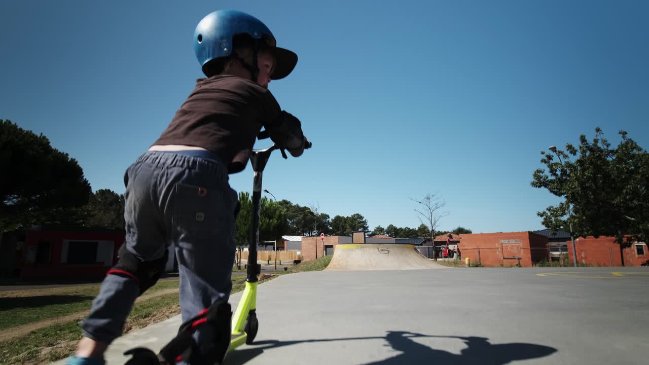 Child Riding Scooter in Skatepark