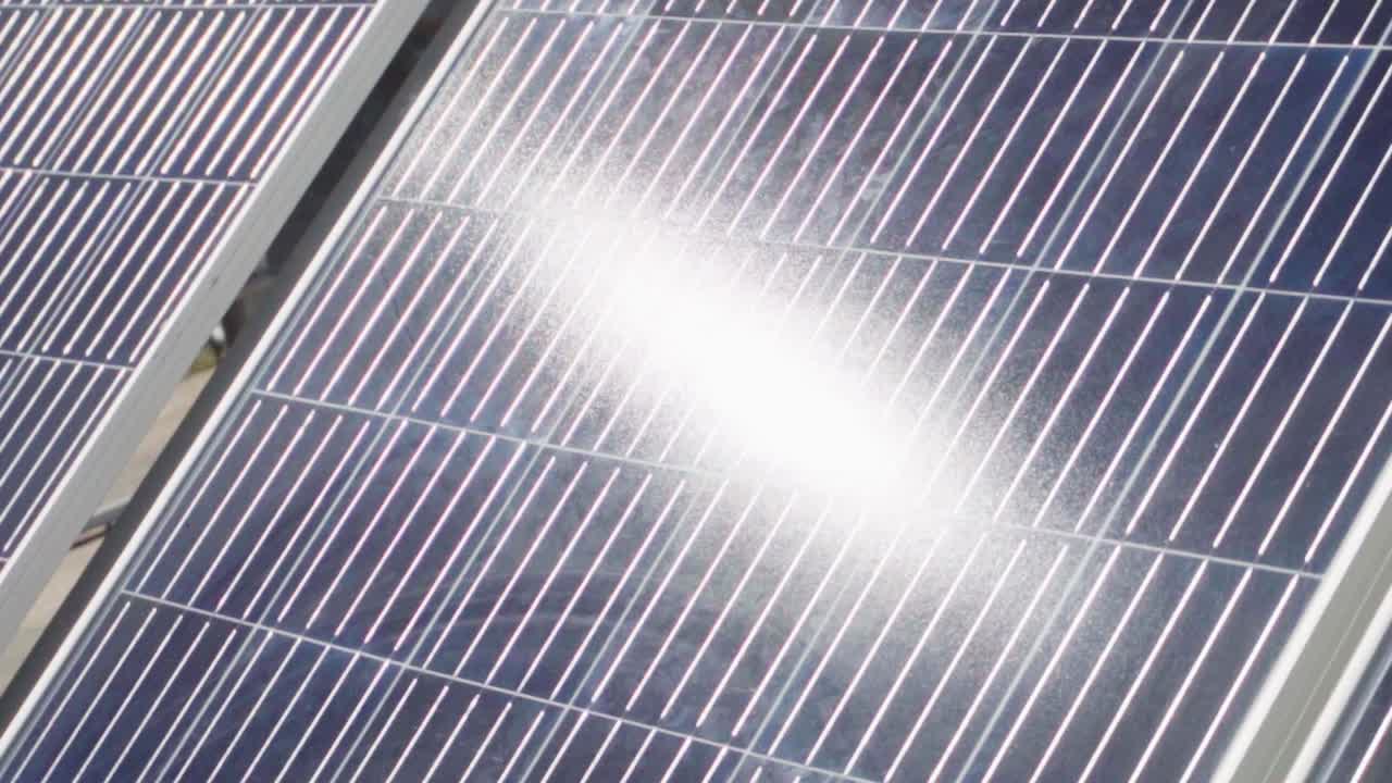 primer plano giratorio a cámara lenta de un reflejo del sol en un panel solar