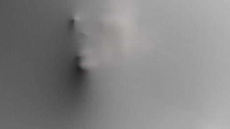 a creepy silhouette of a woman's face appears screaming from the white surface