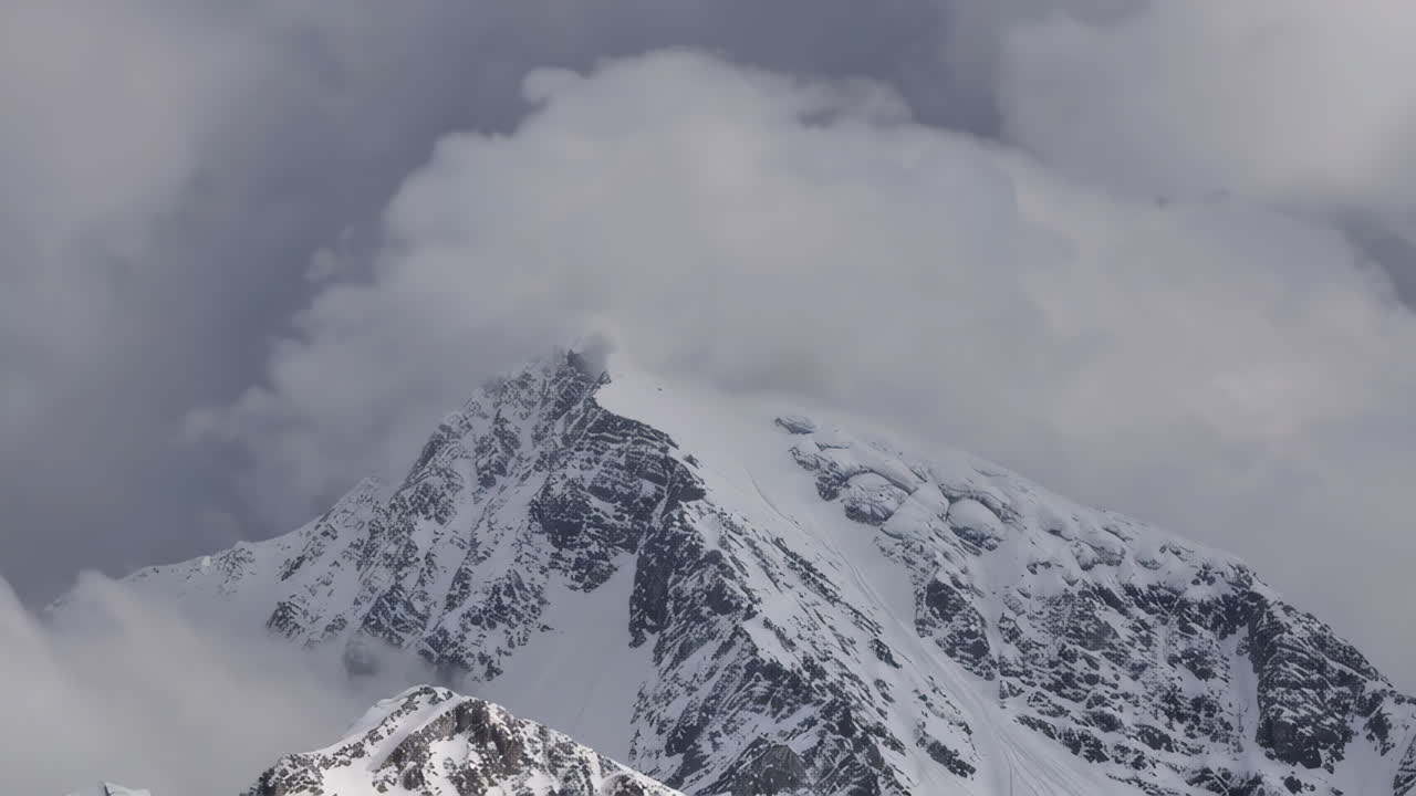 Snowy Mountain Peak Covered in Clouds