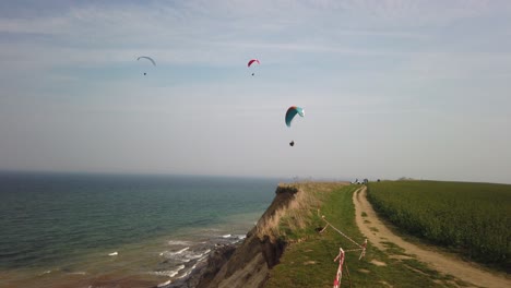 some-paragliders-fly-along-the-steep-coast-of-the-Baltic-Sea