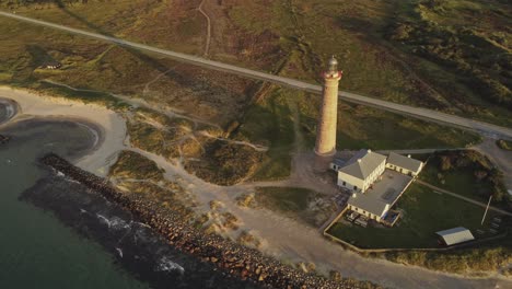 gray lighthouse in skagen near grenen beach natural park, denmark