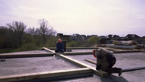 construction workers framing a roof