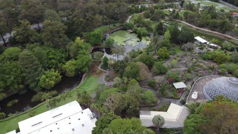 Aerial-view-of-a-beautiful-Botanical-Garden-with-ponds-and-a-glass-dome