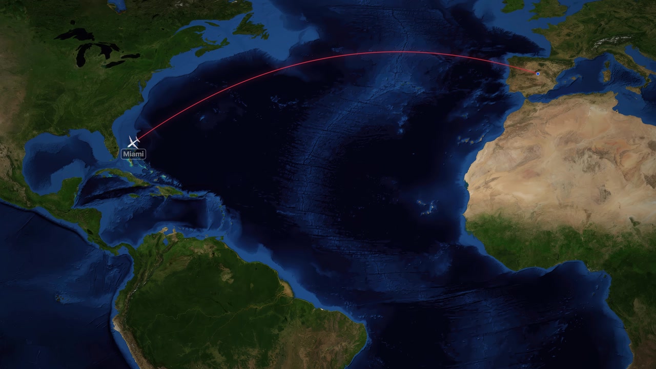 Satellite map animation tracks a commercial airplane flying across the Atlantic from Madrid to Miami