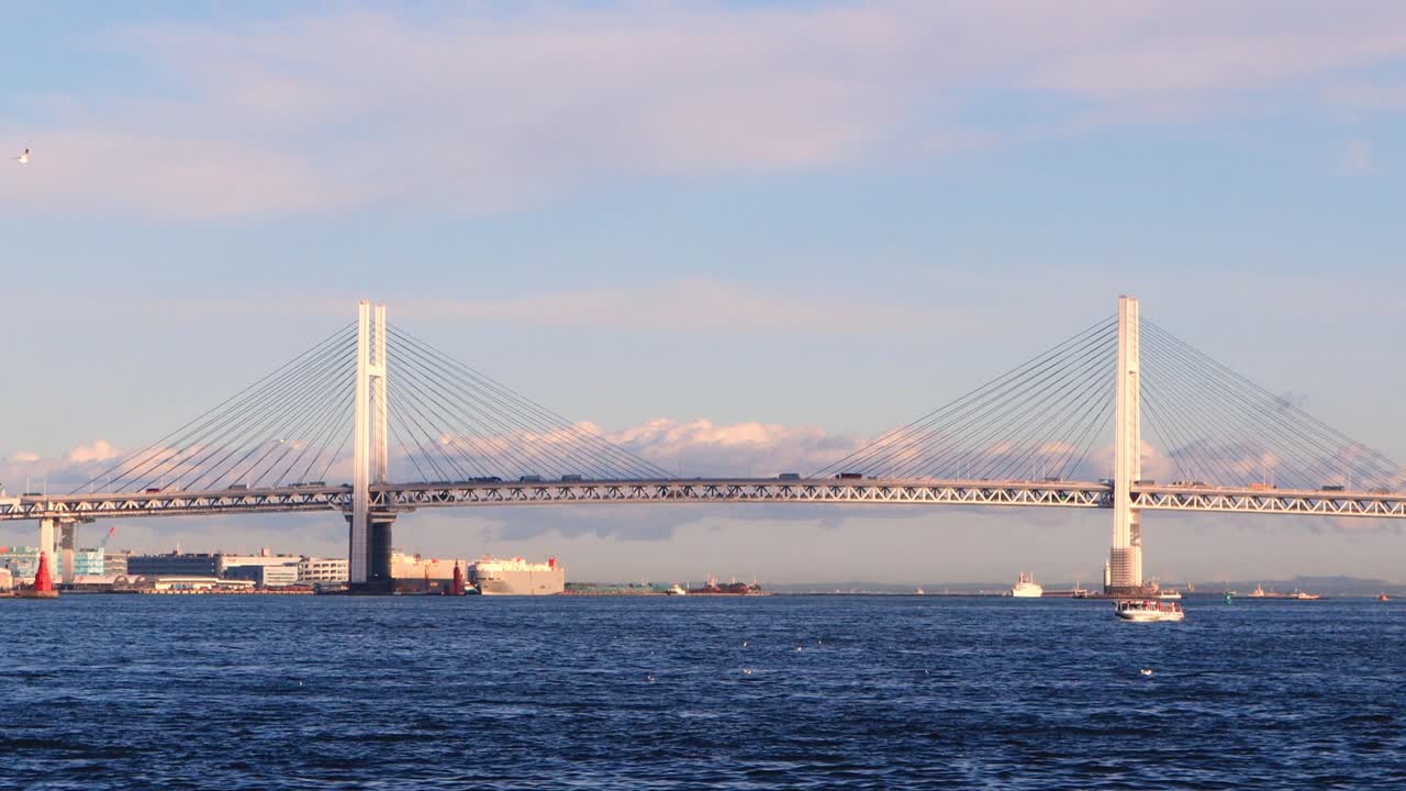 Vehicles crossing the Yokohama Bay using the bridge in the distance. Zoom out and Pan