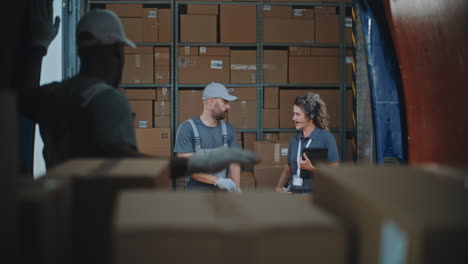 workers sorting and handling packages in a delivery truck or warehouse