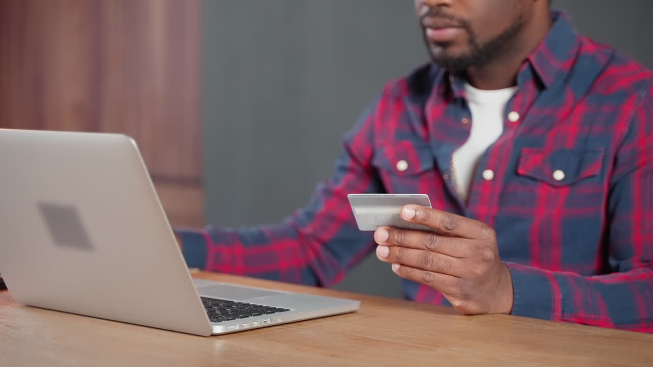 Uomo che usa un laptop e una carta di credito per fare acquisti online