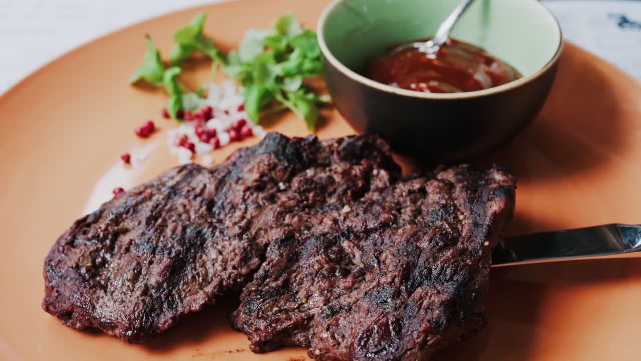 Close up of a Sirloin Steak with Barbecue Sauce and micro-plants on the side