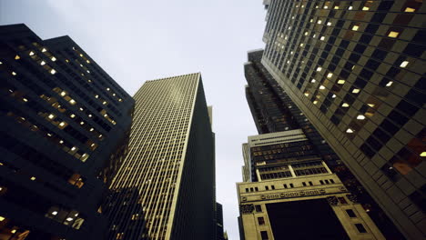 tall urban buildings rising toward the cloudy sky at dusk in the city