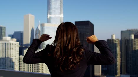 latin american female celebrating business success overlooking chicago