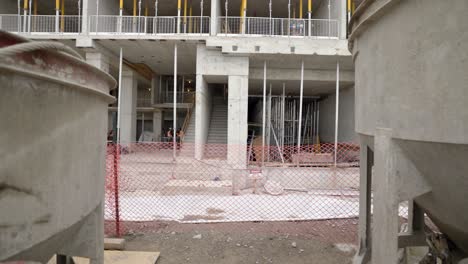 condominium construction site with concrete buckets and formwork