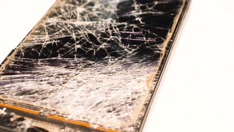 an old smartphone with a broken screen. an old smartphone with a broken screen. macro rotation. repair of smartphones