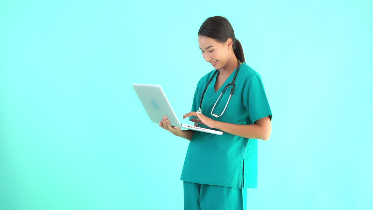 Female Doctor Standing Up and Holding Laptop. Copy Space