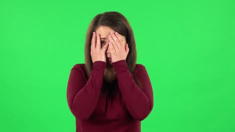 woman covering her face, appearing sad and distressed