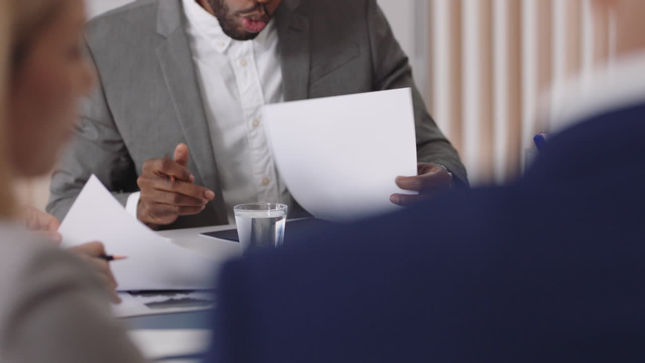 african american businessman team leader meeting with colleagues sharing creative ideas for startup project discussing corporate strategy in office boardroom