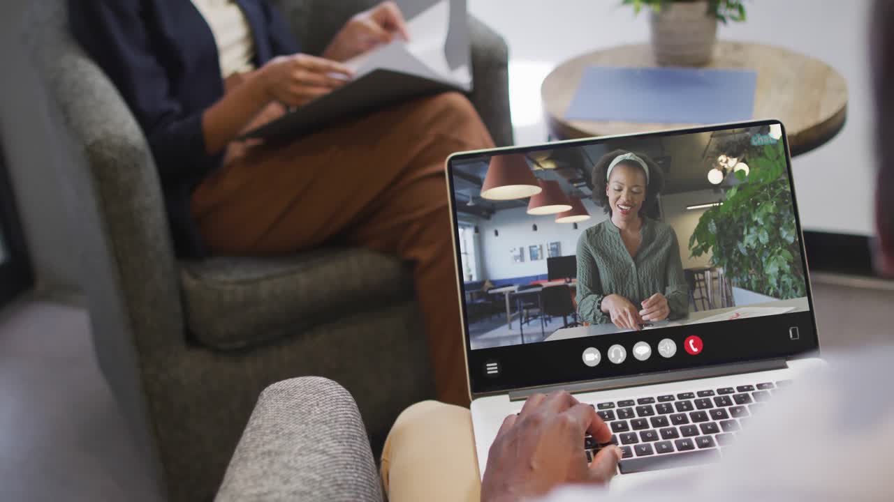 African american man using laptop for video call, with business colleague on screen