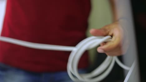 crew member coils up a cable while preparing for a television broadcast