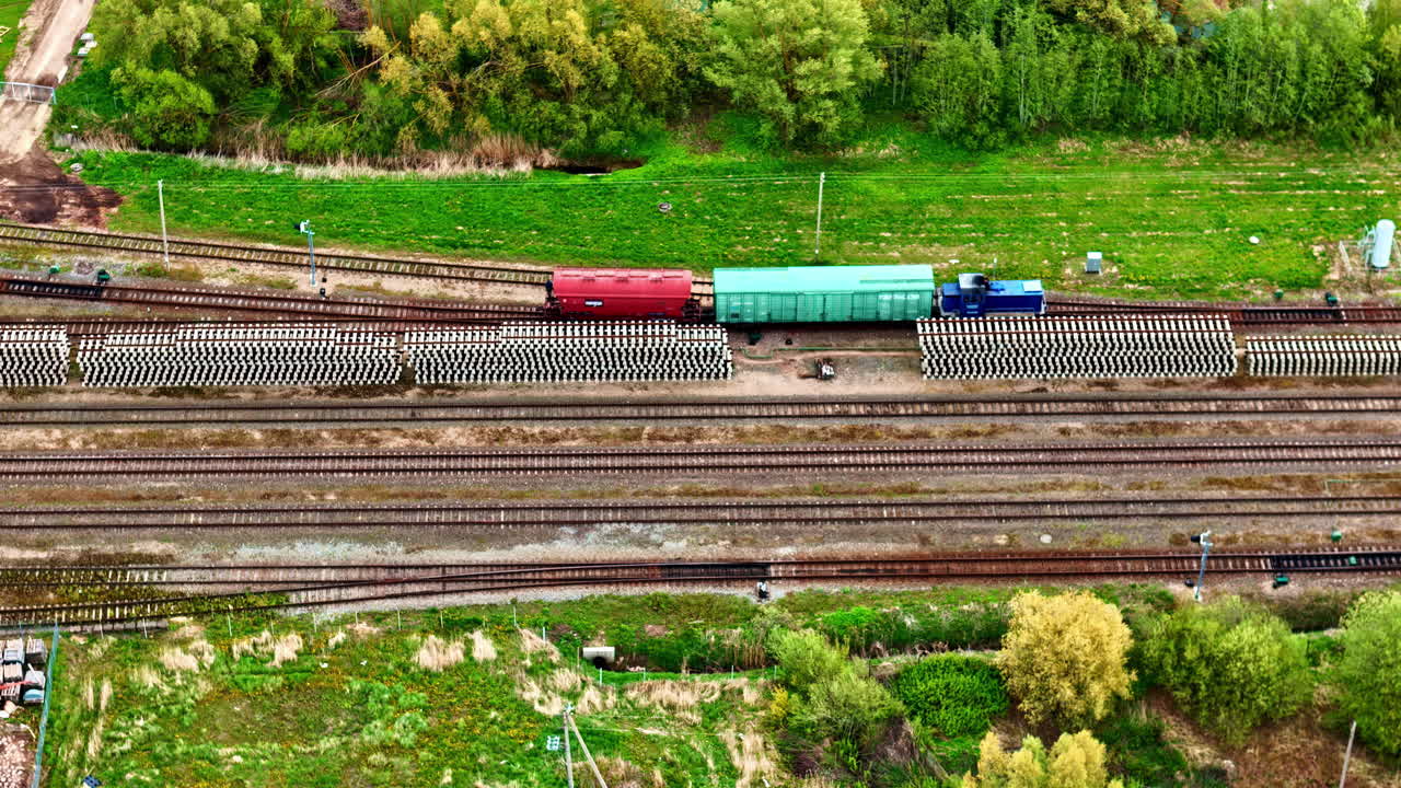 Beautiful aerial view of goods train in Joniškis travelling through farmland