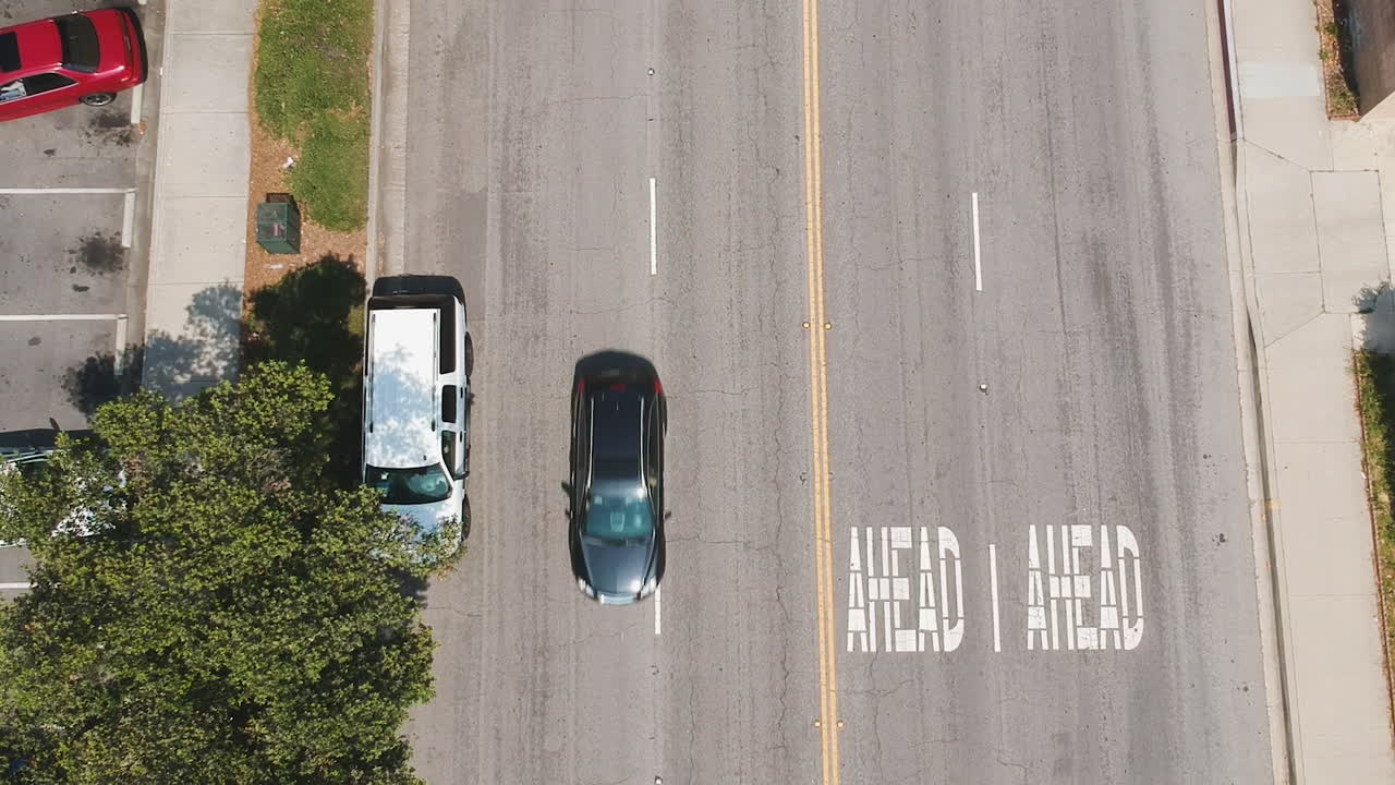 Drone footage of the community during the summer. School getting out, parents getting home, people enjoying the community center