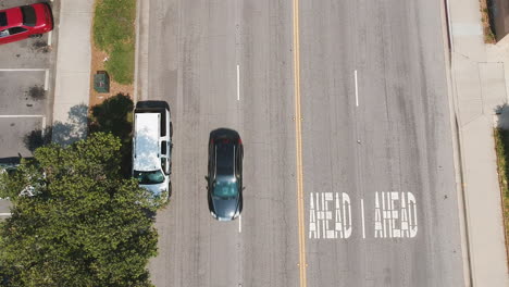 drone footage of the community during the summer. school getting out, parents getting home, people enjoying the community center