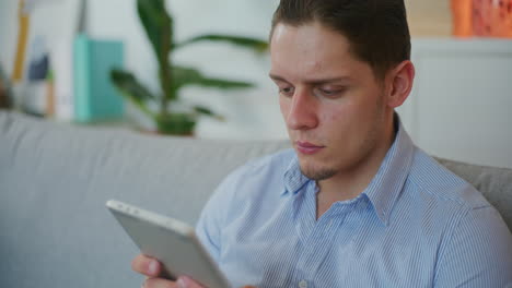 confident man uses digital tablet