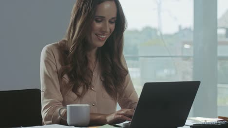 Business-woman-working-at-laptop-computer.-Happy-person-chatting-on-notebook.