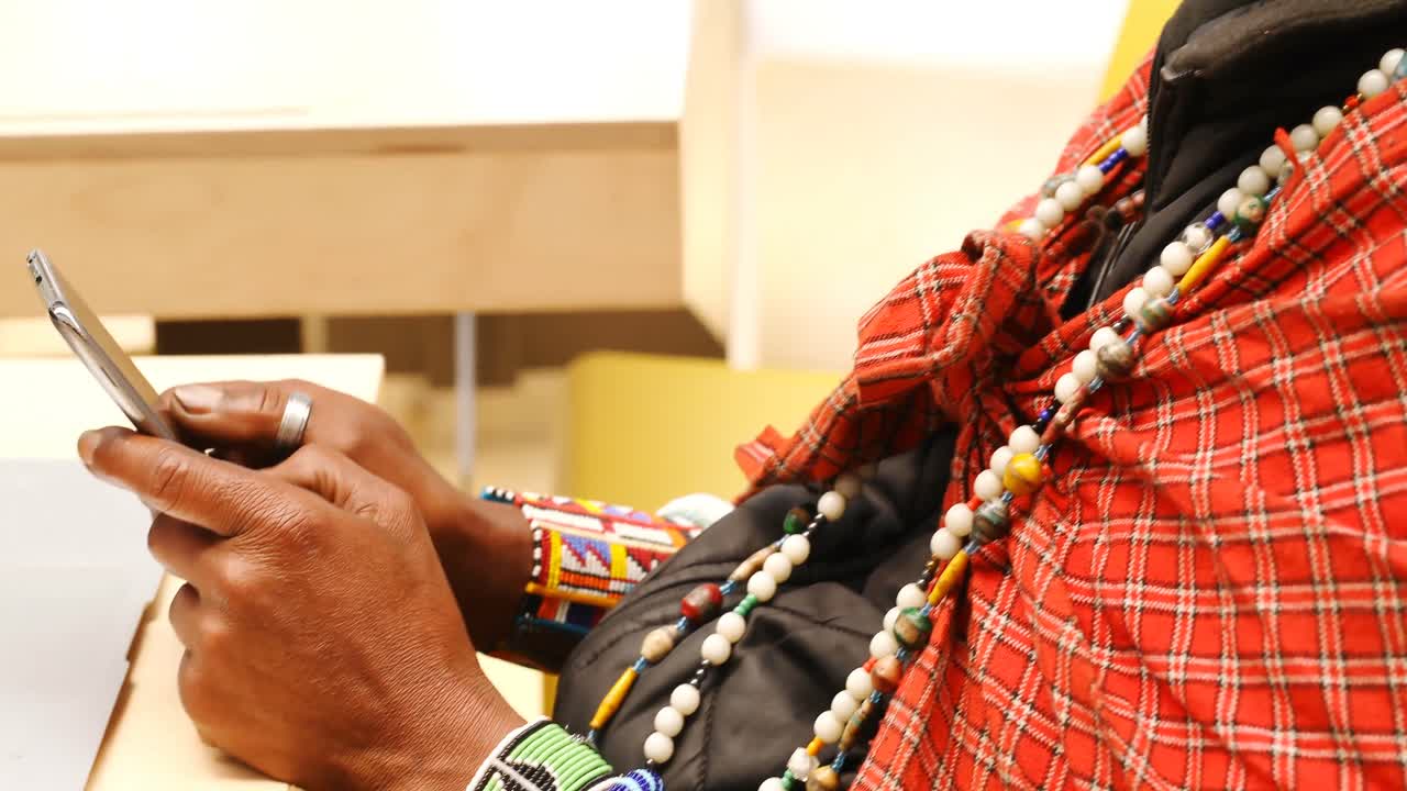 hombre tribal usando teléfono móvil y portátil 4k