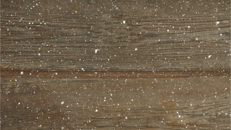 animation of snow falling over wood board