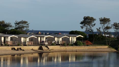 static view of a house by a tranquil lake